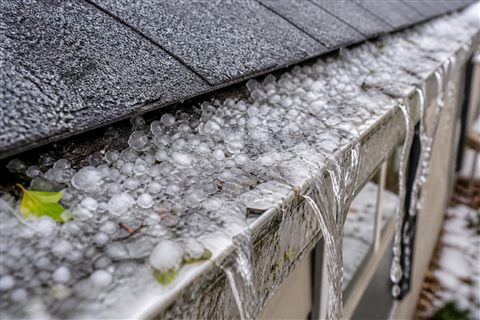 Ice-clogged gutter before cleaning